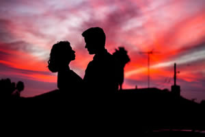 Couple embracing in a pink sunset