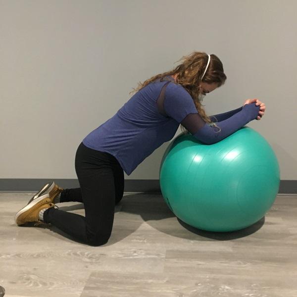 upright labor positions hip ER on ball | image courtesy of Femina Staff 