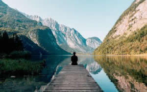 Man Meditating on a Dock