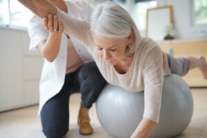 Woman working with a physical therapist on muscle coordination and pelvic stability.